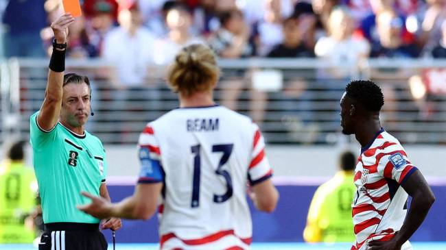 Raphael Claus shows Folarin Balogu red card at World Cup