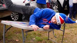 Bills fan jumping through folding table