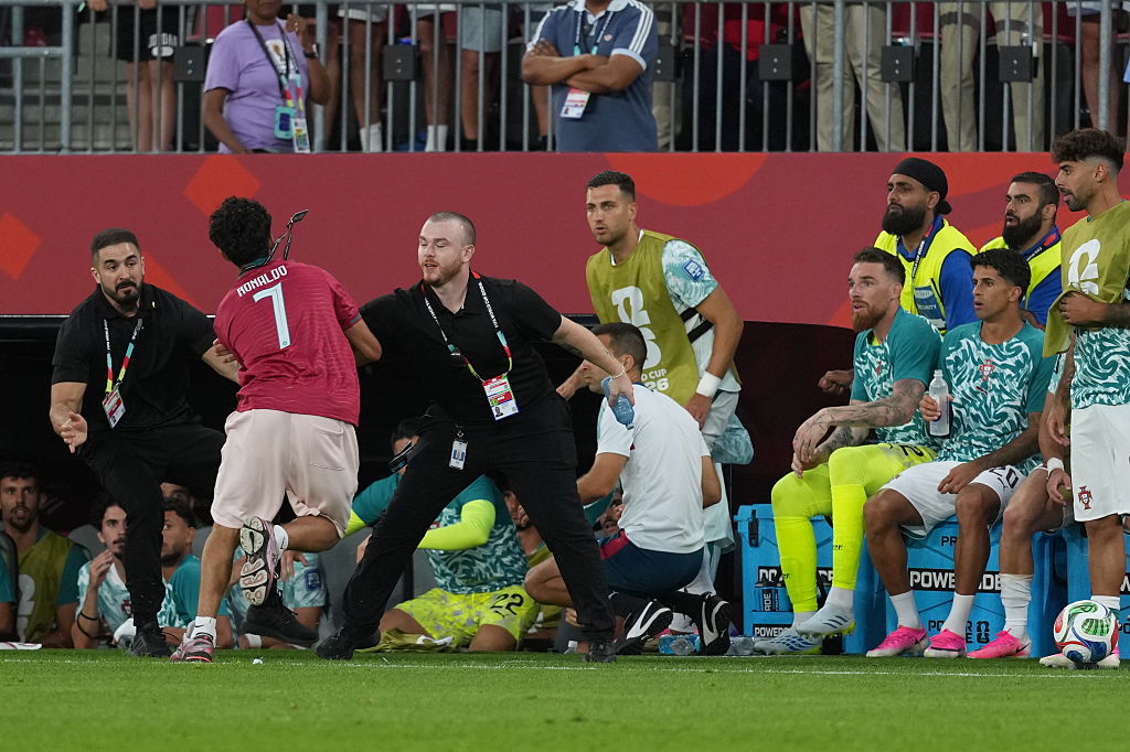 Cristiano Ronaldo streaker pitch invader world cup diogo dalot tackle