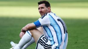 Lionel Messi sits on field after World Cup loss to Spain