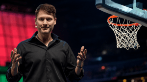 Tech millionaire Bryan Johnson speaks at a web summit with a stock image of a basketball hoop added to the top right of the photo.