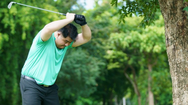 Angry golfer slamming club