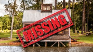 Missing sign over wood cabin on lake