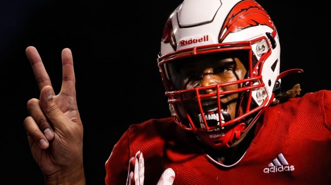 Davenport running back Cephus Harris next to peace sign