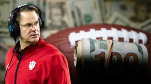 Indiana coach Curt Cignetti next to roll of money on a football