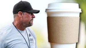 Detroit Lions coach Dan Campbell next to coffee cup