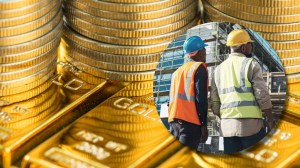 Gold bars and coins next to construction workers