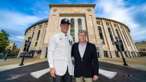 New York Yankees chairman Hal Steinbrenner standing with Aaron Judge