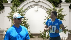 Los Angeles Chargers Head Coach Jim Harbaugh and quarterback Justin Herbert in front of a wedding display