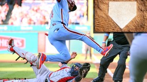 Philadelphia Phillies Luis Arraez jumping over home plate avoiding a tag