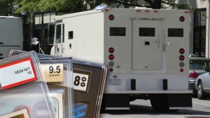 Graded sports cards next to armored truck