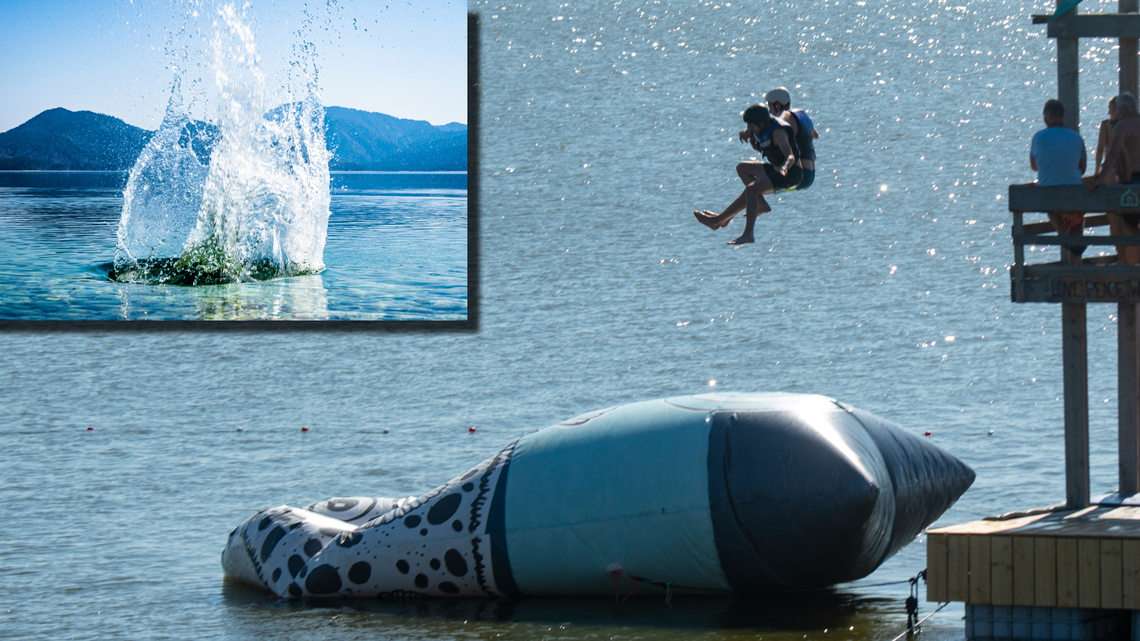Two people jumping onto a Water Blob water trampoline aka 'The Blob'
