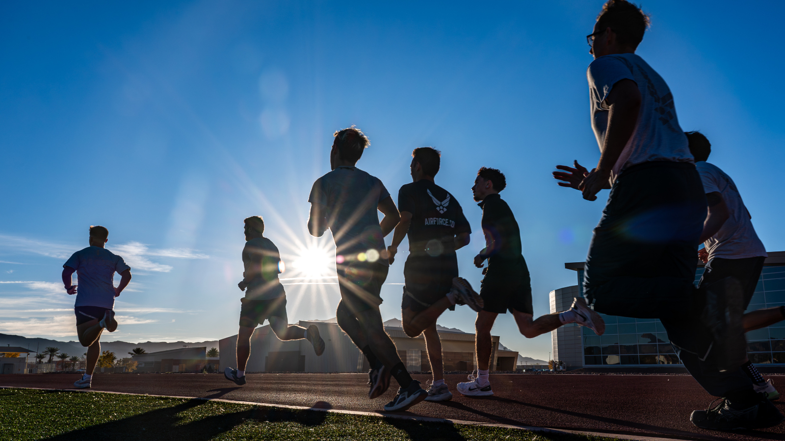 members of the United States Air Force running on a track