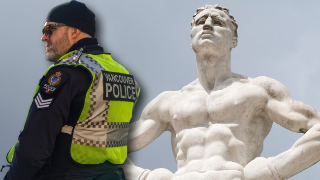 Vancouver police officer next to marble sculpture