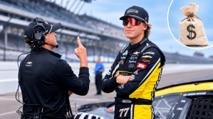 NASCAR Cup Series driver Carson Hocevar (77) stands by his car Saturday, July 25, 2026, during qualifying for the Brickyard 400 at Indianapolis Motor Speedway with a stock image of a money bag in the top right corner.