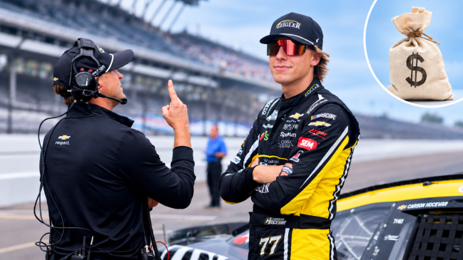 NASCAR Cup Series driver Carson Hocevar (77) stands by his car Saturday, July 25, 2026, during qualifying for the Brickyard 400 at Indianapolis Motor Speedway with a stock image of a money bag in the top right corner.