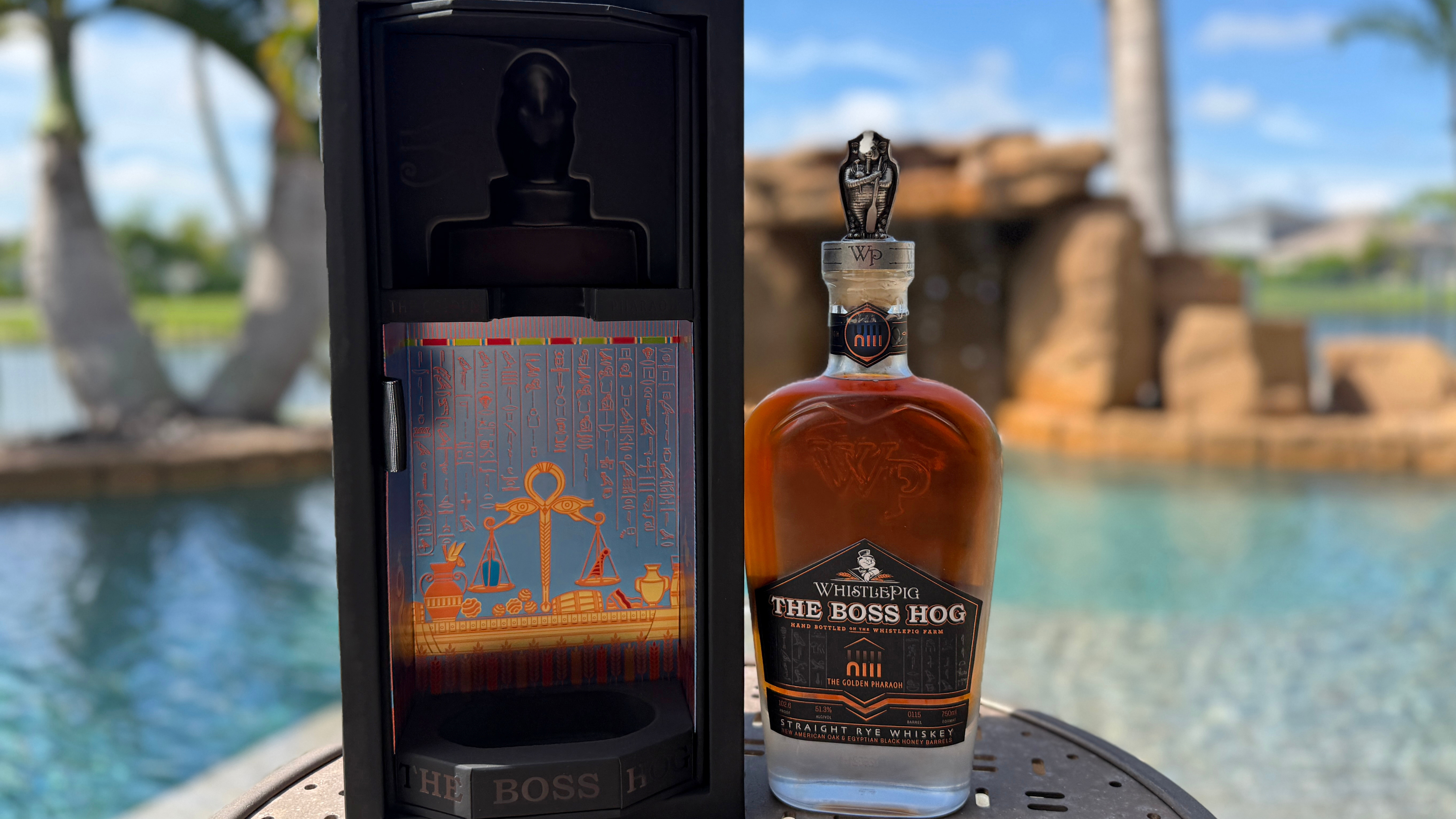 WhistlePig The Boss Hog XIII: The Golden Pharaoh bottle outdoors next to pool