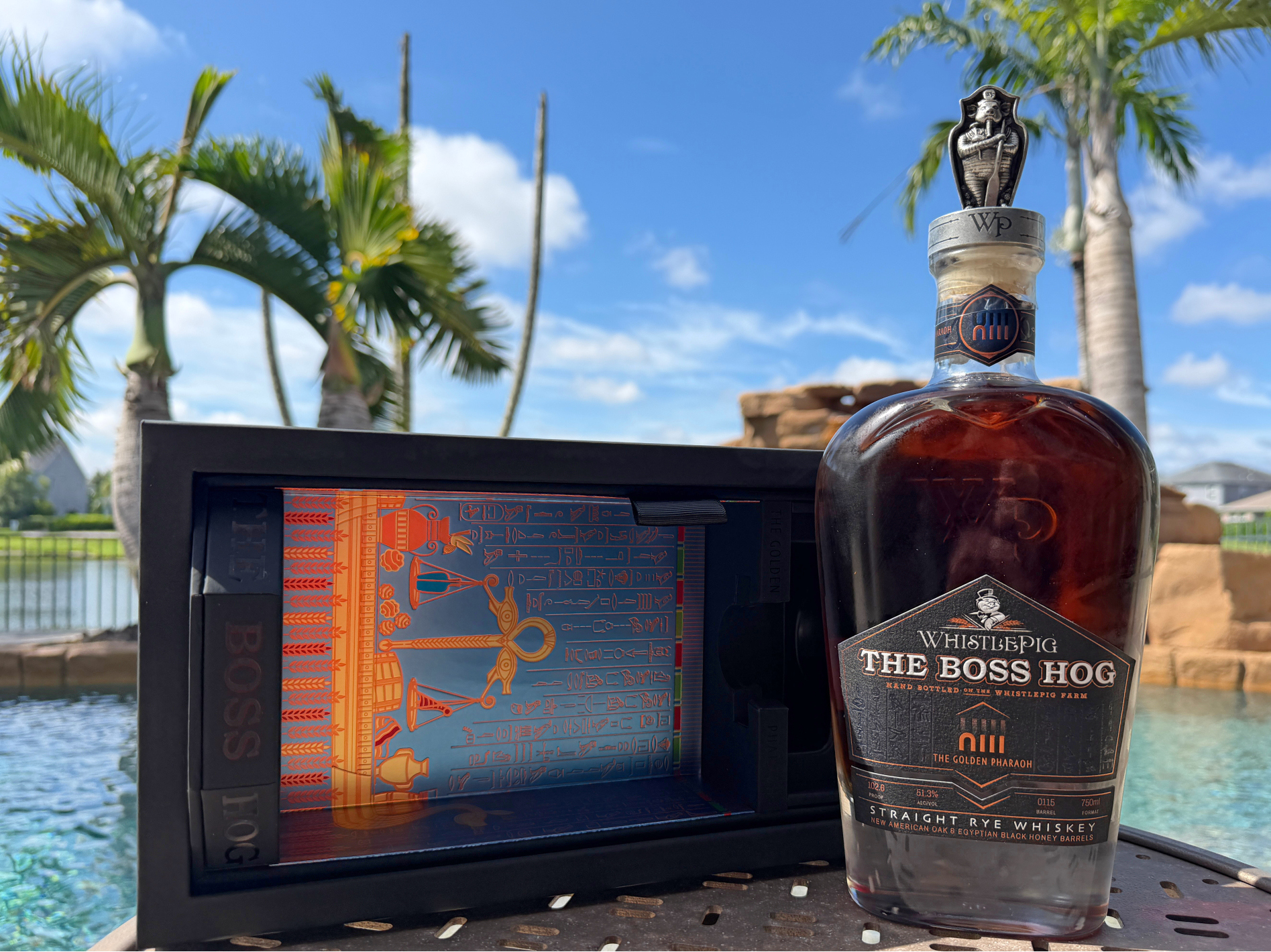 WhistlePig The Boss Hog XIII: The Golden Pharaoh bottle outdoors next to pool