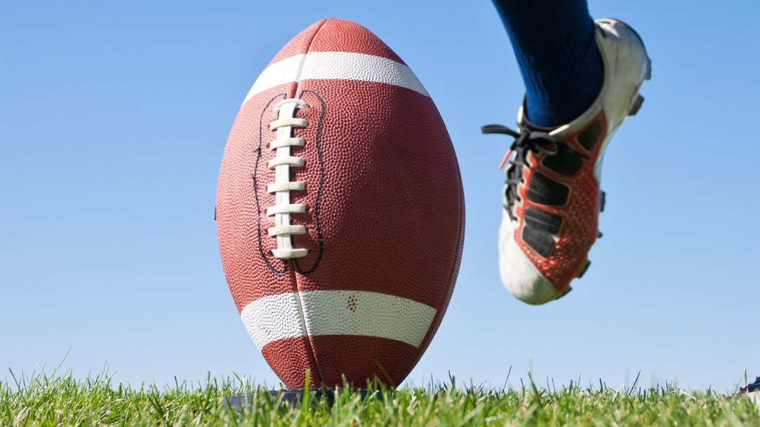 high-school-player-kicking-football