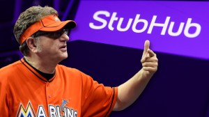 Laurence Leavy, a.k.a Marlins Man, next to StubHub logo