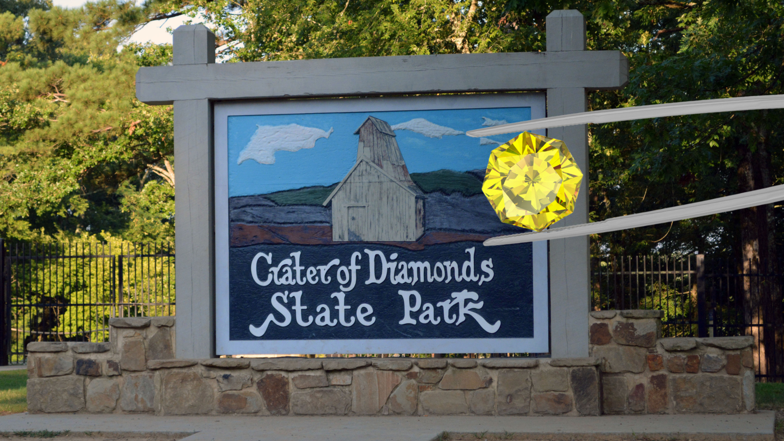 6 carat yellow diamond in front of Crater of Diamonds State Park sign in Arkansas
