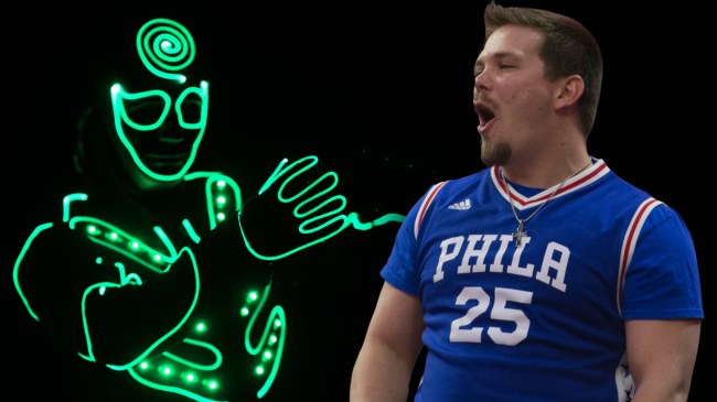 Philadelphia 76ers fan next to performer wearing an LED suit