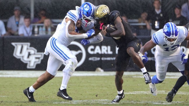 Oct 24, 2026; Orlando, Florida, USA; Central Florida Knights wide receiver Tyren Hornes (2) is hit by Brigham Young Cougars linebacker Isaiah Glasker (16) during the third quarter at Acrisure Bounce House.