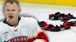 Brady Tkachuk next to jerseys thrown onto the ice by Senators fans