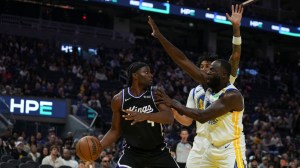 SAN FRANCISCO, CALIFORNIA - OCTOBER 10: Precious Achiuwa #9 of the Sacramento Kings looks to pass the ball while defended by Draymond Green #23 and Yaxel Lendeborg #1 of the Golden State Warriors during the first half of the preseason game at Chase Center on October 10, 2026 in San Francisco, California.