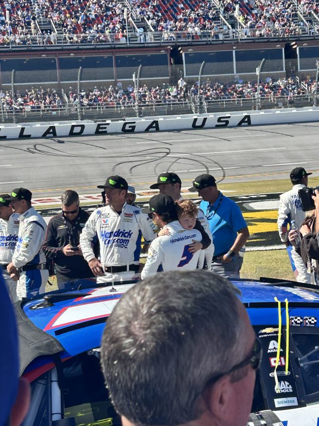 NASCAR driver Kyle Larson holds his son Cooper prior to the 2026 YellaWood 500 at Talladega Superspeedway.