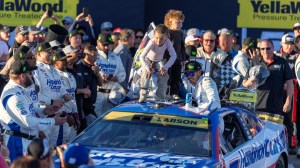 Oct 25, 2026; Talladega, Alabama, USA; NASCAR Cup Series driver Kyle Larson (5) arrives in Victory Lane after winning the YellaWood 500 NASCAR Cup Series race at Talladega Superspeedway. He's joined by his daughter Audrey and son Cooper.
