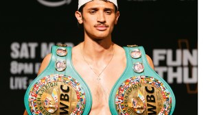 Sebastian Fundora poses with WBC belts.