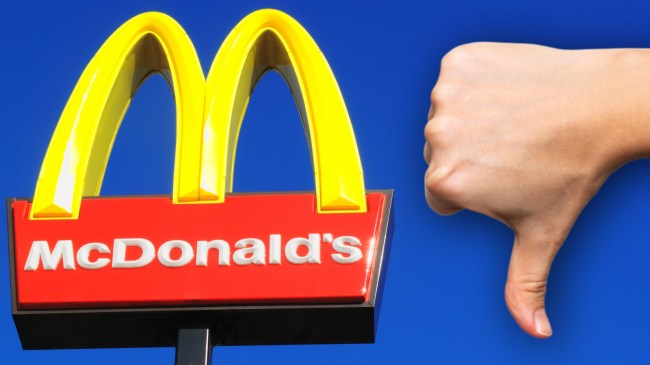 McDonald's sign next to person giving a thumbs down